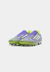 Lightweight soccer cleats in purple and green, featuring a textured upper, streamlined design, and molded studs for traction. Accented with white stripes.