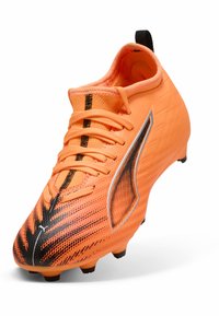 Oranje voetbalschoenen met gestructureerde synthetische bovenkant, zwarte accenten en een gestroomlijnd ontwerp. Voorzien van vetersluiting en stevige grondstuds.
