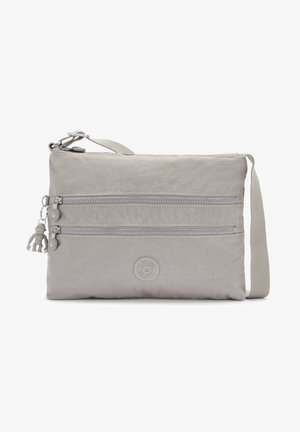 Gray fabric crossbody bag with two zippered pockets, a textured surface, logo patch, adjustable strap, and a decorative monkey charm.