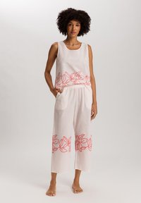 Conjunto de dos piezas de lino en rosa claro que incluye una blusa sin mangas con un patrón floral y pantalones de pierna ancha con cintura elástica y bolsillos laterales.