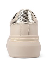 Sneaker color crema con punta testurizzata in oro metallico, corpo in materiale sintetico liscio e suola spessa con accenti lucidi.