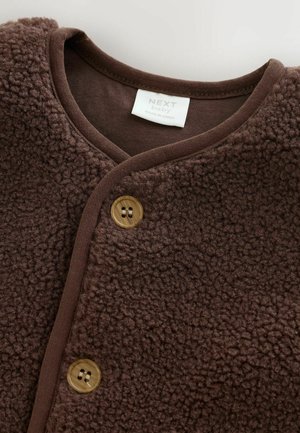 Brown fleece jacket with a soft texture, featuring a V-neck, brown trim, and two round buttons for closure. Label reads "NEXT baby."