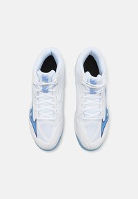 White athletic shoes with mesh details and blue accents. Features a lace-up design, padded collar, and textured sole for grip.