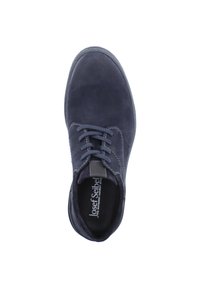 Dark blue suede shoe with a rounded toe, lace-up front, and contrasting stitching details. Interior branded lining visible. Flat rubber sole.