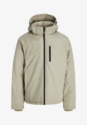 Veste isolée beige avec une fermeture éclair sur le devant, un col montant et une capuche ajustable. Équipée d'une poche poitrine et de poches latérales. Texture douce.