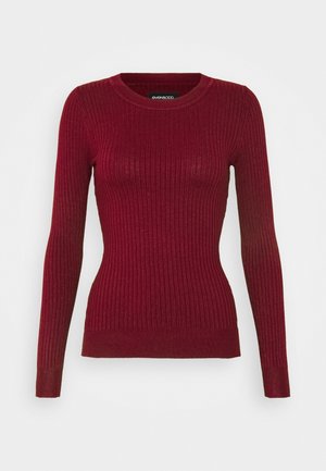Red ribbed long-sleeve sweater with a round neckline. Features a fitted silhouette and textured fabric, with subtle stretch.