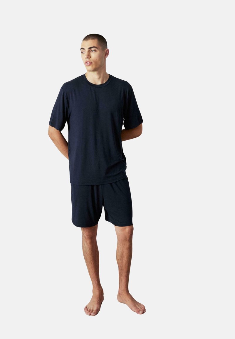 Conjunto de loungewear de algodón azul marino que incluye una camiseta de manga corta y pantalones cortos a juego, con un ajuste relajado y una textura suave.