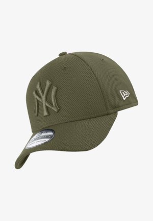 Olive green mesh cap with embroidered NY logo, curved visor, and adjustable strap. Features a tag with size information.