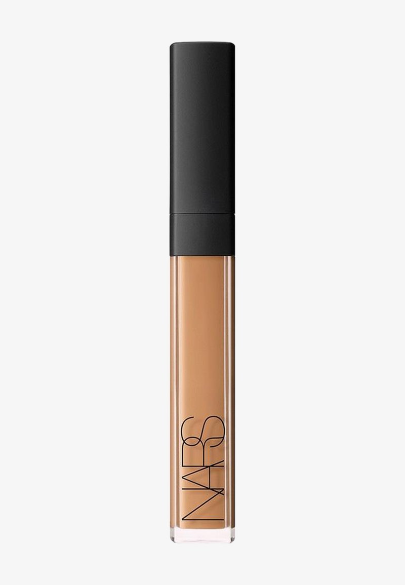 Concealer tube with beige liquid makeup and matte black cap, branded with “NARS” text on a light background.