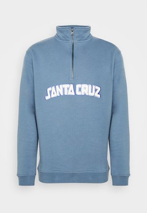 Sudadera azul de manga larga con medio cierre en el cuello y texto blanco "Santa Cruz" en el pecho.