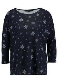 Top à manches longues bleu marine à coupe décontractée avec des motifs de flocons de neige blancs sur toute la surface et un large décolleté. Tissu doux et léger.