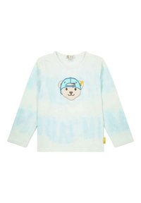 Camisa de manga larga en tie-dye azul claro, con una cara de oso bordada con una gorra azul en la parte delantera. Fabricada en algodón con un corte holgado.