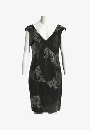Robe noire jusqu'aux genoux avec col en V, manches courtes et motifs abstraits floraux et ponctués argentés sur un mannequin.
