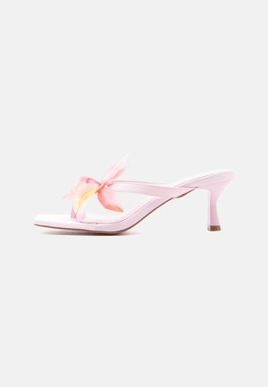 Light pink heeled sandal with a slender strap and decorative pink and yellow fabric flower on the front.