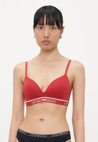 Rode naadloze bh met een driehoekig cupontwerp, smalle verstelbare bandjes en een gebrandmerkte elastische band met "EMPORIO ARMANI" in het wit.