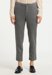 Grijze geruite broek met een getailleerde pasvorm, voorzien van een knoopsluiting en schuine zijzakken. Gemaakt van een gestructureerde stof.