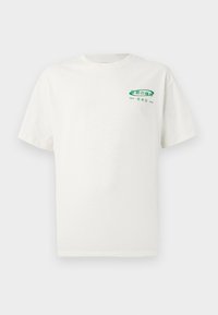 White cotton t-shirt with short sleeves, featuring a green graphic print on the left chest that includes Japanese text and city names.
