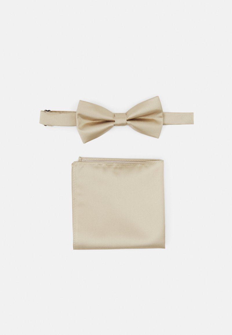 Beige satin bow tie with matching pocket square, featuring a smooth texture and classic bow design. Both accessories are neatly arranged.