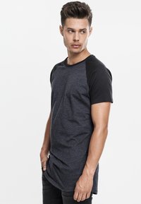 Gray and black short-sleeve T-shirt with a round neckline and relaxed fit, featuring a contrasting black shoulder design and soft texture.