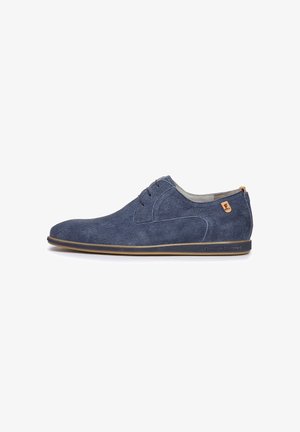 Scarpe casual di colore blu navy realizzate in tessuto texturizzato, con punta arrotondata, design stringato e un accento in pelle color cuoio sul tallone.