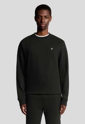 Sort sweatshirts lavet af blødt stof med rund hals, lange ærmer og et lille gråt logo på venstre brystområde.
