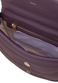 Purple leather handbag interior, featuring a zip pocket and a light purple lining, with a gold hardware closure and accent.