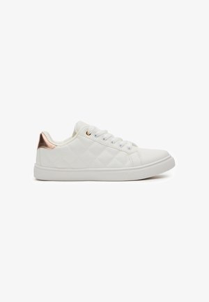 Zapatillas de deporte blancas acolchadas con una textura suave, con un acento de oro rosa en el talón y suela de goma resistente. Cintas con seis ojales.