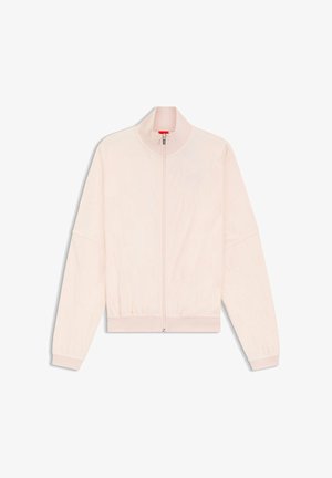 Vaaleanpunainen vetoketjullinen takki pystykauluksella, jossa on teksturoitu kangas hienovaraisella kuviolla sekä joustavat hihansuut ja helma.