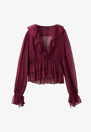 Blouse bordeaux transparente à manches longues avec col en V volanté, volants à la taille et poignets cintrés avec liens.