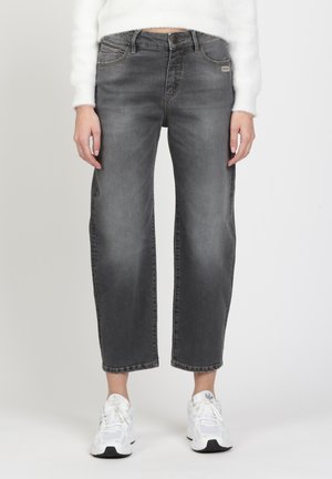 Gray denim jeans with a relaxed fit, featuring a high waist, five-pocket design, and subtle fading. Paired with white sneakers.