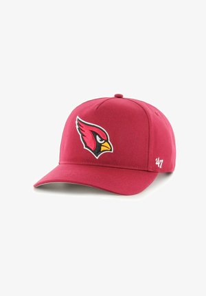 Red baseball cap made of fabric with a structured crown. Features a black and yellow embroidered bird logo on the front and a curved brim.
