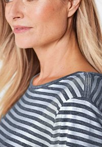 Gestreepte grijs-witte longsleeve top met een ronde halslijn, gemaakt van zachte stof en met een comfortabele pasvorm. Opvallende schouderdetails.