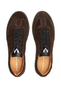 Zapatillas de ante marrón con cordones y acentos negros. Punta redondeada, cuello acolchado y logo en la lengüeta. Plantilla color marrón claro.