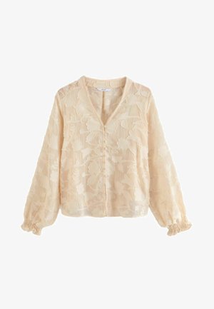 Krämfärgad blus med blommig broderi, V-ringning och knappdetalj fram. Långa ärmar med elastiska muddar och genomskinlig textur.