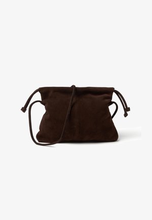 Dark brown suede drawstring pouch bag with long thin strap and cinched top edges against white background.