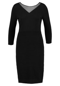 Robe noire ajustée à manches longues, décolleté en V et panneau transparent. Détails en côtes texturées le long du corps ajoutent de la dimension.