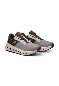 Running shoes with a light gray upper, dark gray accents, and a cushioned sole featuring circular cutouts. Lace-up closure and textured surface.