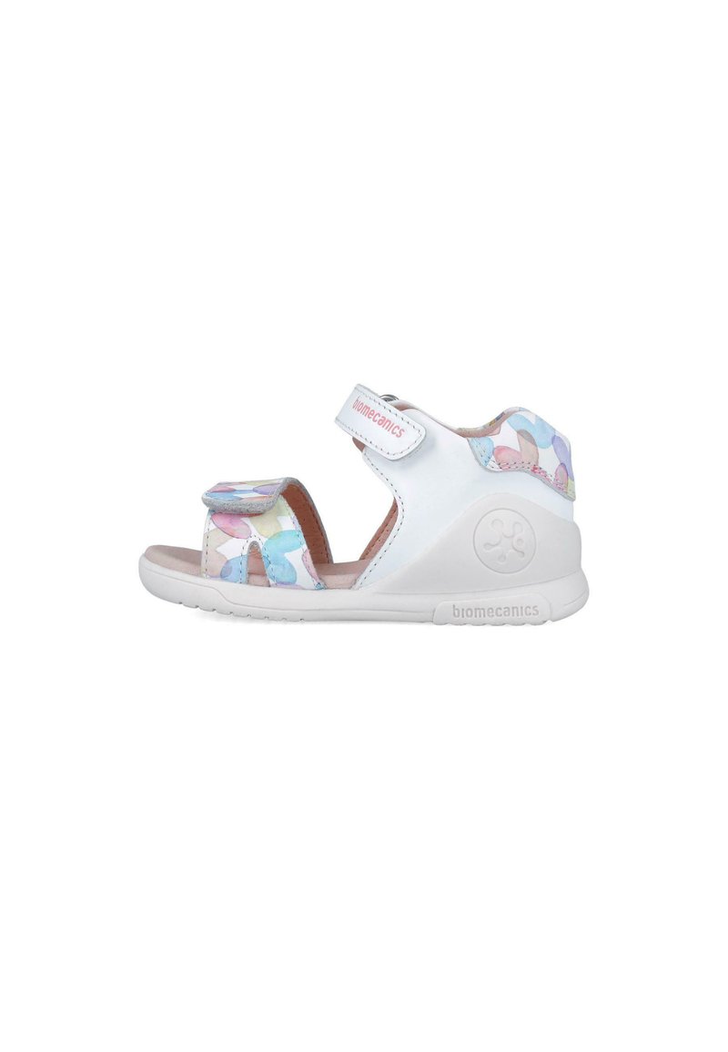 Sandalo bianco con una cintura decorata da colori pastello. Chiusura regolabile in velcro e suola in gomma. Design leggero per il comfort.