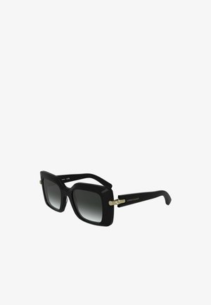 Czarne, oversize okulary przeciwsłoneczne z gradientowymi soczewkami. Oprawa ma matowe wykończenie i złote akcenty. Logo umieszczone na zauszniku.
