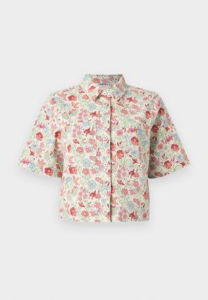 Kortermet cropped skjorte med knapper og krage, laget av kremfarget stoff med et fargerikt blomsterprint i rødt, rosa, blått og grønt.