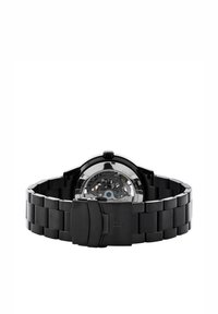 Reloj de acero inoxidable negro con fondo de caja visto, presentando una caja redonda, banda integrada y un cierre seguro. Mecánica interna visible.