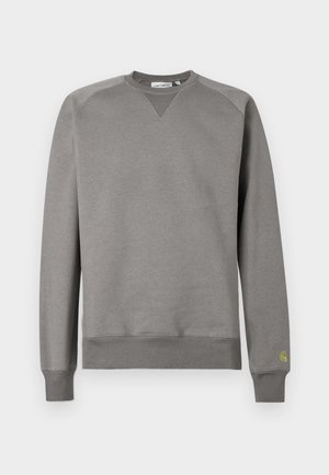 Harmaa collegepaita pehmeästä kankaasta. Siinä on resorit hihansuissa ja helmassa, pyöreä pääntie sekä pieni vihreä logo vasemmassa hihaosassa.