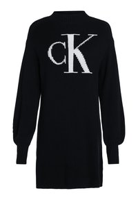 Robe pull en maille noire avec des manches longues, un col montant et un grand logo blanc "CK" sur le devant. Texture canalée sur l'ensemble.