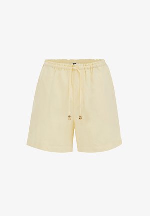 Világos sárga, hétköznapi rövidnadrágok gumis derékrésszel és húzózsinórral, amely apró fa gyöngy díszítéseket tartalmaz.