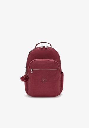 Burgundy fabric backpack with a rounded shape, two zip compartments, a front pocket, a side pocket, and a teddy charm attached.