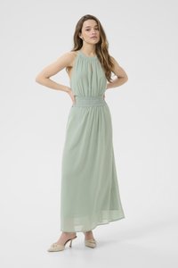 Maxi dress in soft green fabric with a halter neck, keyhole detail, and lace-accented waistband. Features flowing, lightweight material.