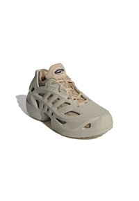 Beige sneaker with open cut-out design, mesh tongue, lace-up front, and "Climacool" label on padded tongue, angled to show side and front.
