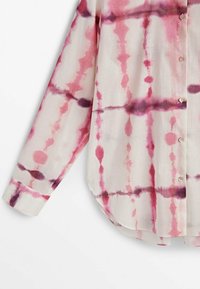 Long-sleeved, lightweight blouse in sheer fabric features pink and purple tie-dye patterns with a straight hem and button-down front.