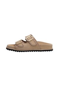 Beige suede slide sandals with two adjustable straps, gold hardware accents, and a textured black rubber sole. Flat design, no heel.