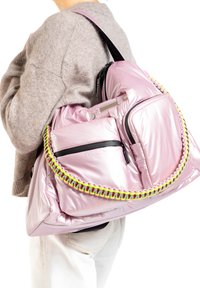 Roze gewatteerde rugzak met een glanzende afwerking, voorzien van zwarte ritsen en een kleurrijke gevlochten schouderband. Grote voorzak met een rits.